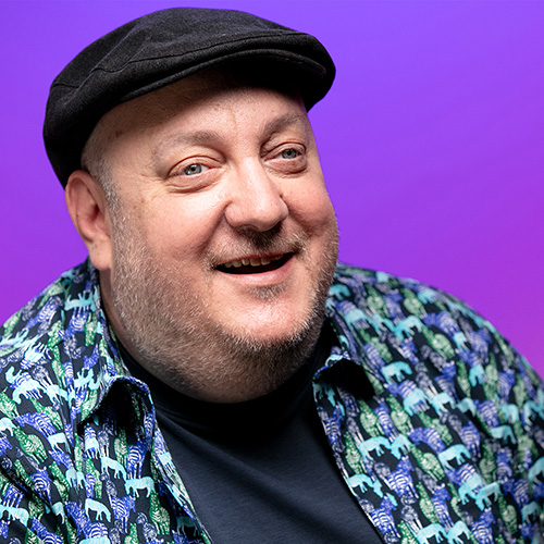 Brian Fischler, That Real Blind Tech Show host and producer, headshot. He is wearing a dark cap and the infamous Zebra shirt that earned him the nickname Zebra boy at the 2021 All Blind Fantasy League draft.